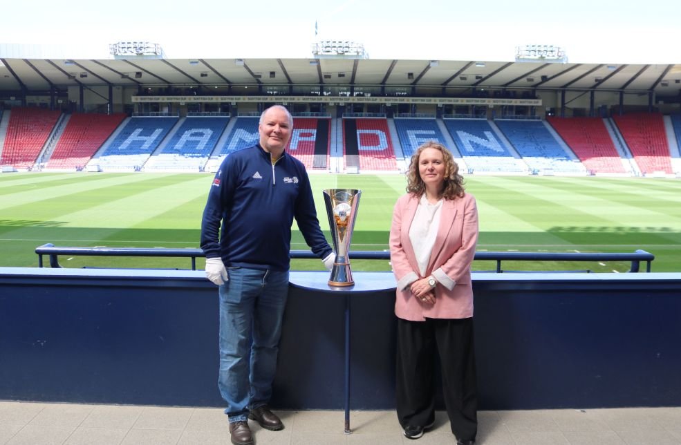 SWF chair Vivienne MacLaren handing over trophy to Scottish Football Museum Curator Richard McBrearty
