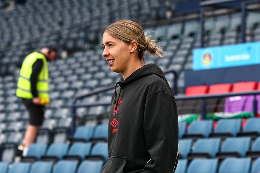 celticvrangersscottishgaswomensscottishcupfinal 1 womensfootballmagazinecom Female athlete in a black hoodie standing in an empty stadium concourse looking to the right