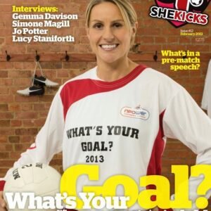 Cover of SheKicks magazine featuring a smiling woman in a white and red football jersey with Whats Your Goal 2013 text against a brick wall background
